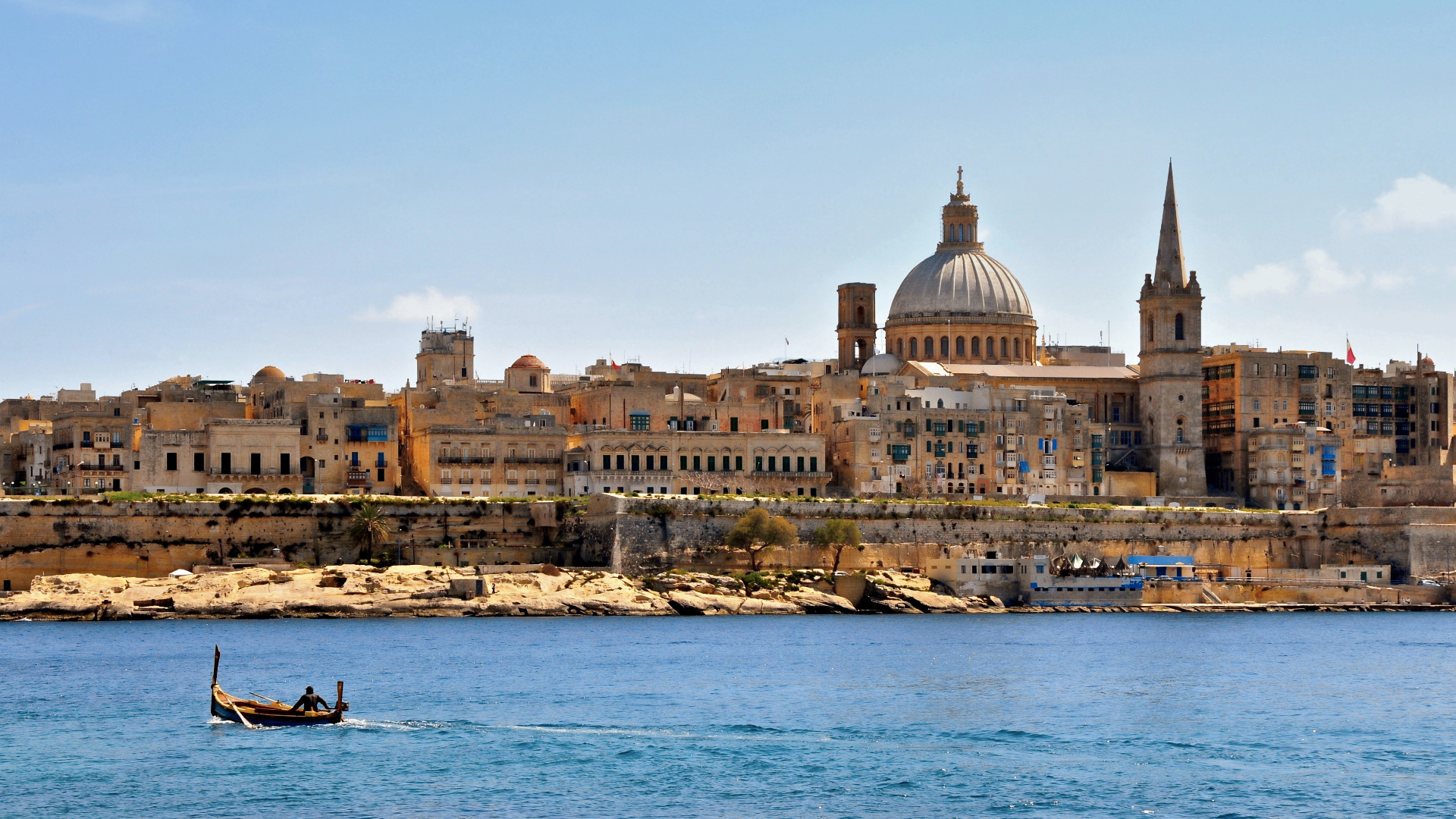 Valletta skyline across the Grand Harbour with historic bastions, dome and spire