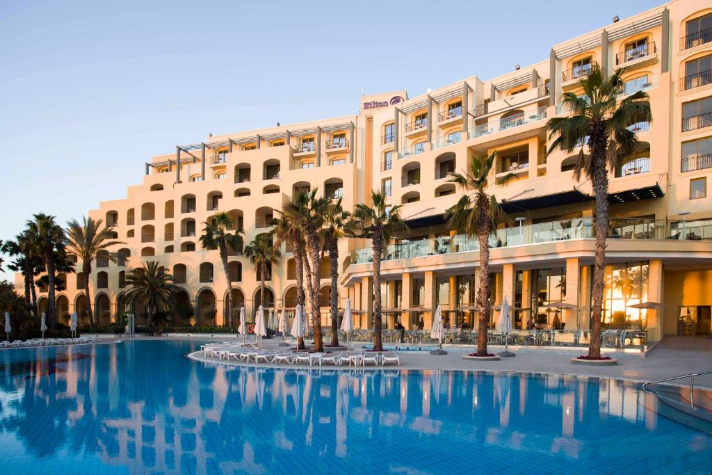 Hilton Malta exterior and pool